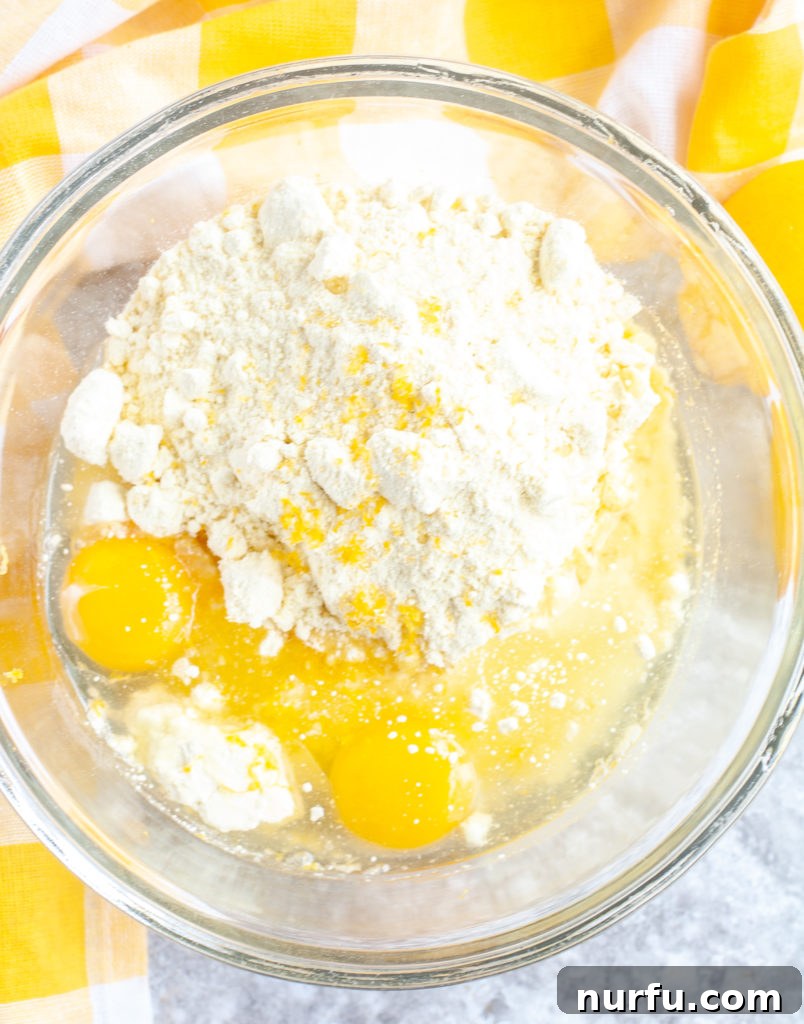 Delicious Lemon Cake Mix Cookie Ingredients Ingredients for lemon cookies artfully arranged in a glass bowl with a yellow checked towel.