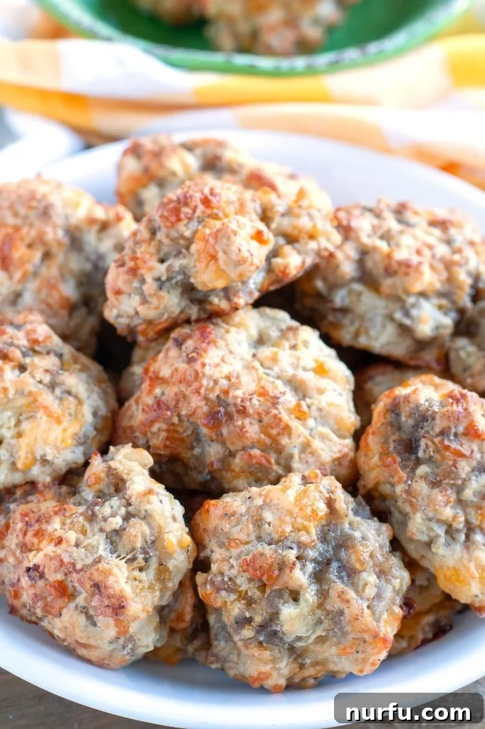 Easy Bisquick Sausage Balls A bowl overflowing with golden-brown, perfectly baked Bisquick Sausage Balls, garnished with fresh parsley.