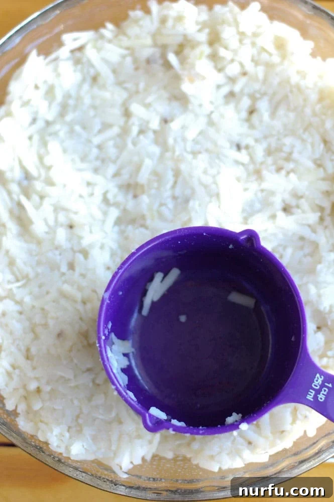 How to press hash browns into a pie dish for a crispy casserole crust. Dried hash browns being pressed into a pie plate with a measuring cup, preparing the perfect crust for a breakfast casserole.