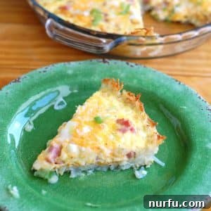 A perfectly baked slice of Hash Brown Crust Breakfast Casserole on a plate, ready to be served.