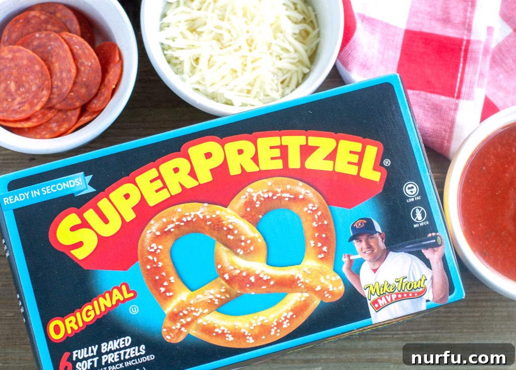 A box of Super Pretzels on a table next to bowls of shredded cheese and sliced pepperoni, ingredients ready for making pretzel pizzas.