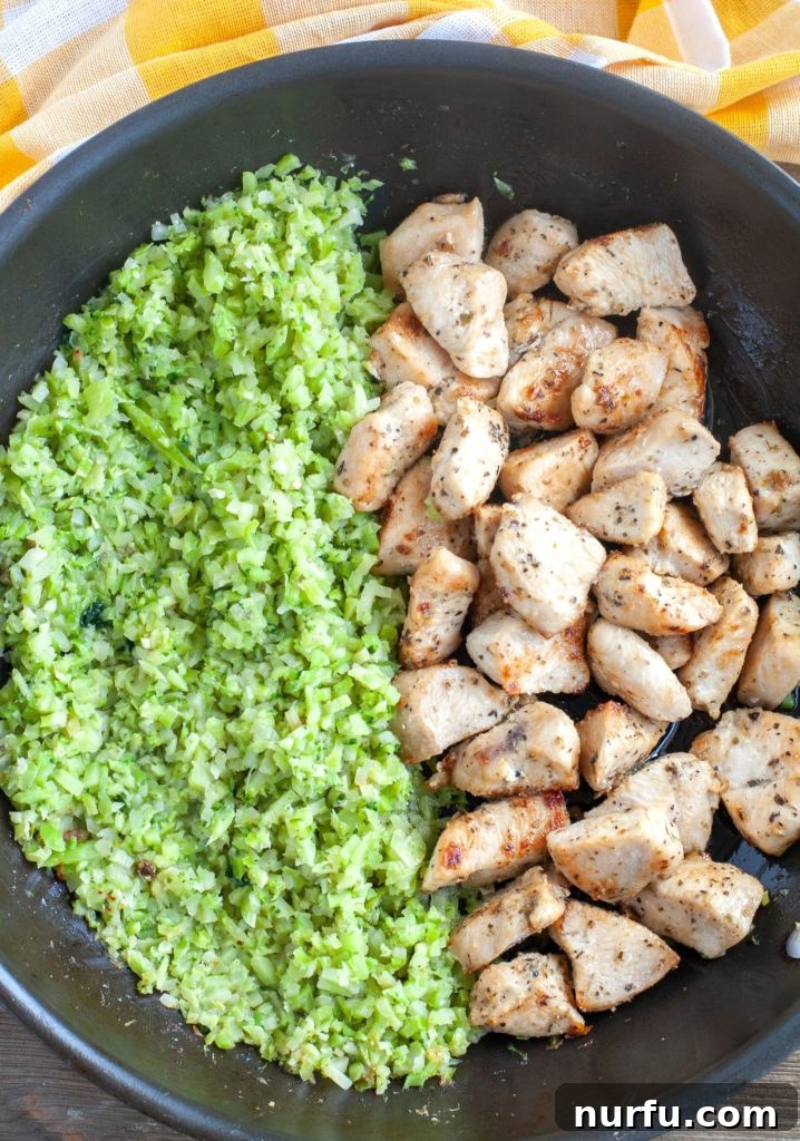 Garlic Butter Chicken Meal Prep Garlic Butter Chicken with riced cauliflower and broccoli in a skillet, ready to serve or portion for meal prep.