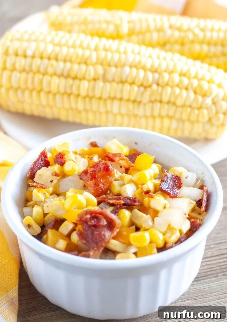 Fried Corn Southern Fried Corn with bacon and onions in a bowl, with ears of corn in the background