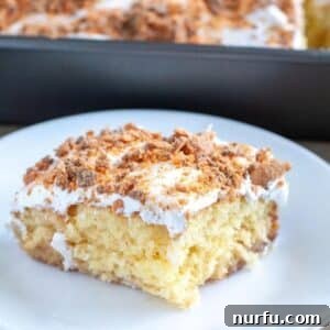 Piece of Butterfinger cake on a plate.