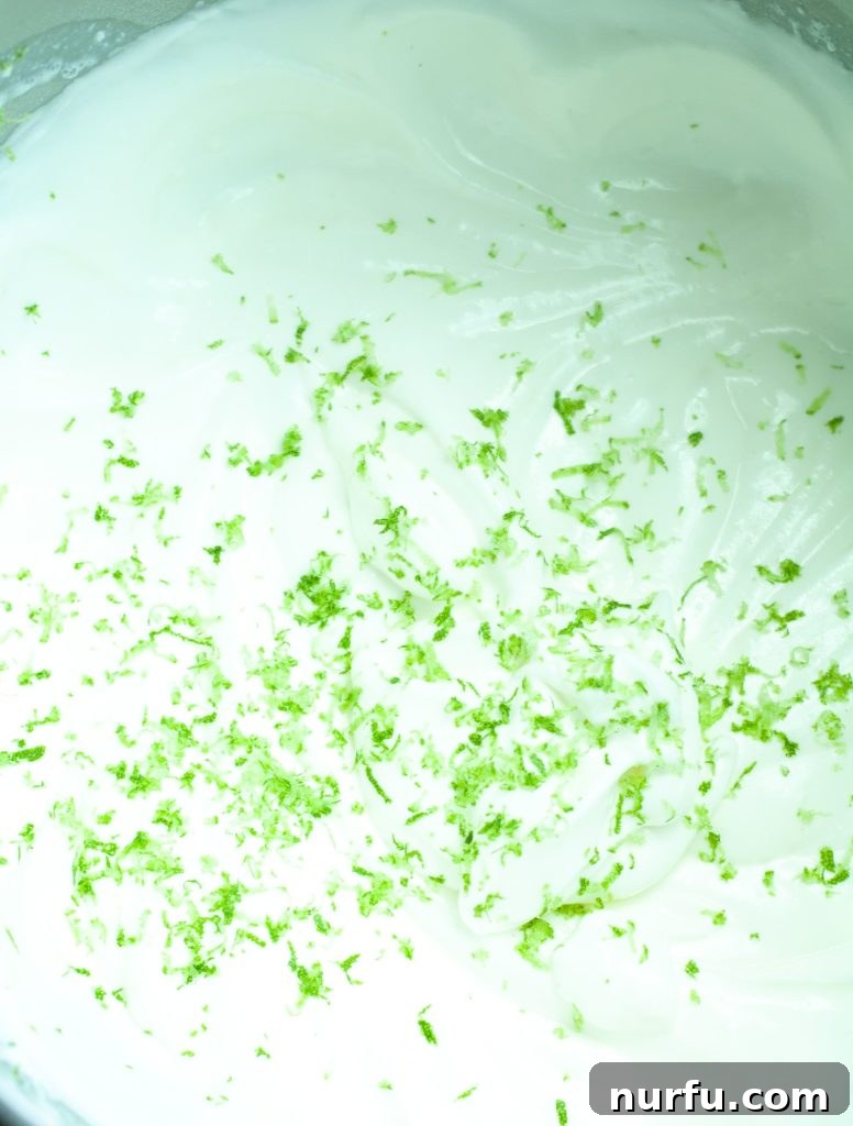 Key lime trifle A bowl filled with creamy Key lime mixture, topped with fresh Key lime zest, ready to be layered.