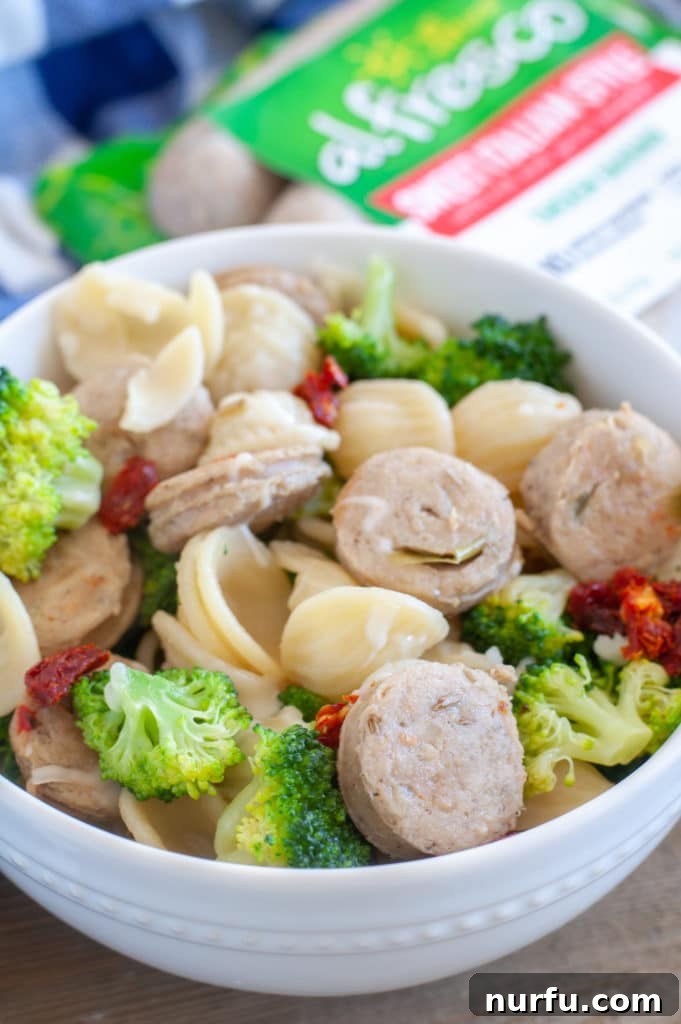 Orecchiette with broccoli and chicken sausage A vibrant bowl of orecchiette pasta, crisp broccoli florets, and perfectly browned chicken sausage, ready to be enjoyed.