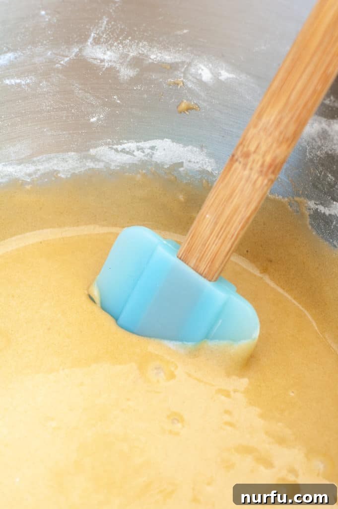 Cream Cheese Swirled blondie Blondie batter in a bowl with a spatula
