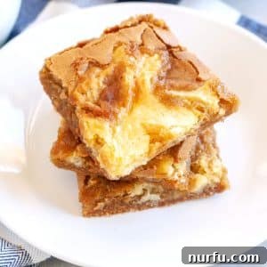 Three blondies stacked on plate.