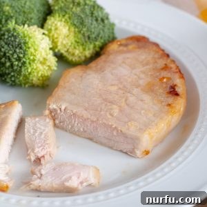 Pork chop on a plate with broccoli.