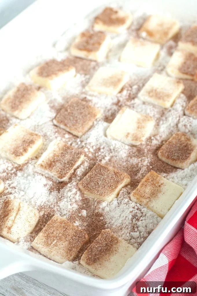 Cake batter with pats of butter on top in casserole dish.