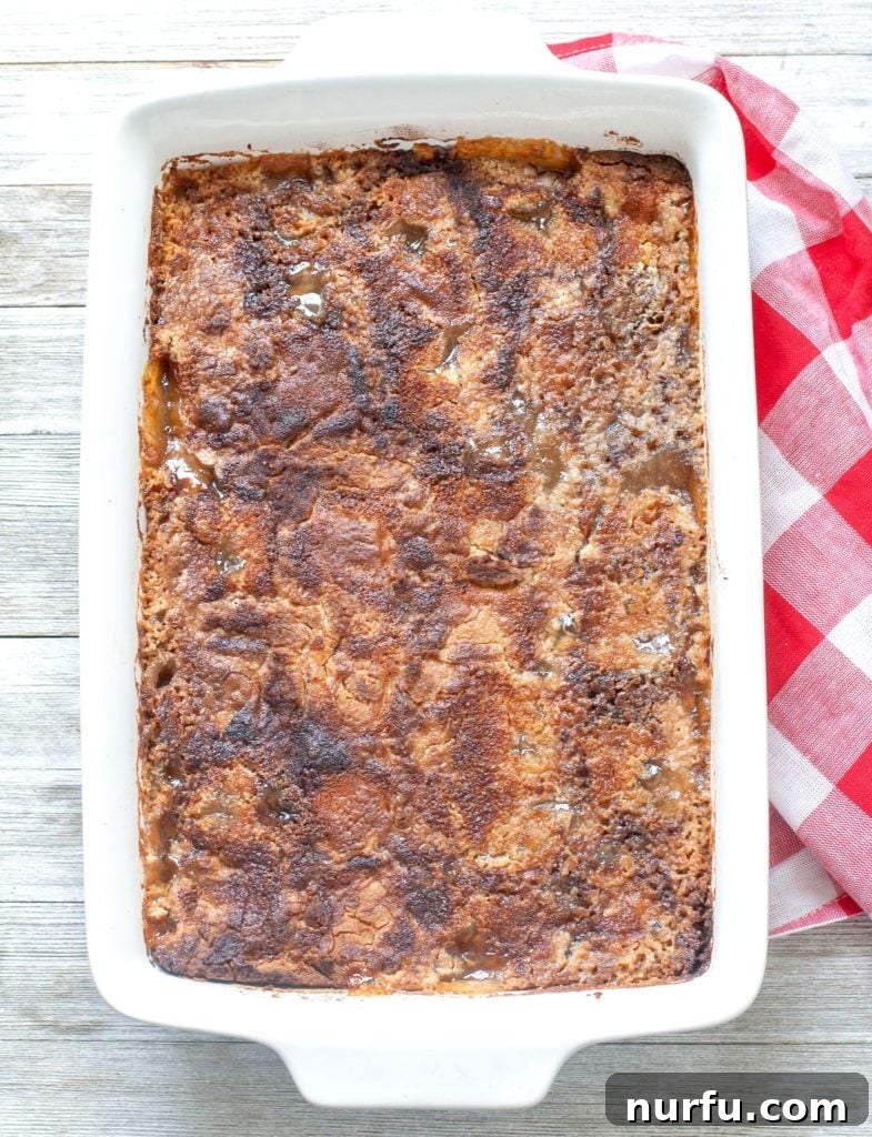 Baked apple pie dump cake in a casserole dish.