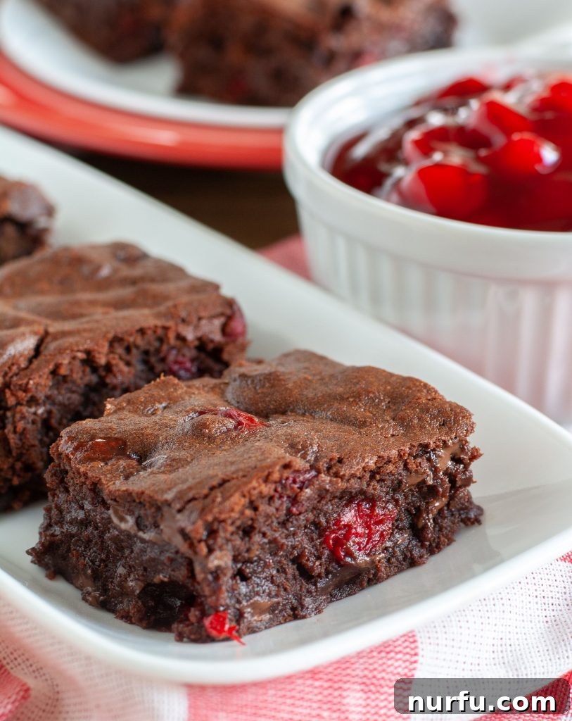 Black Forest Brownies Slice of Black Forest Brownie on a plate, ready to be enjoyed.