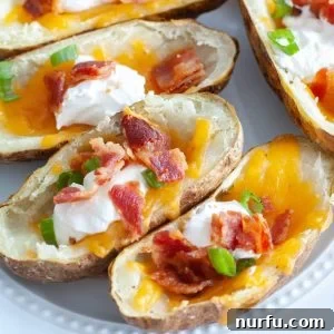 Plate of loaded potato skins make in the air fryer.