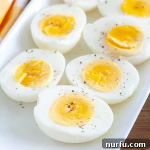 air fryer hard boiled eggs cut in half on a white plate
