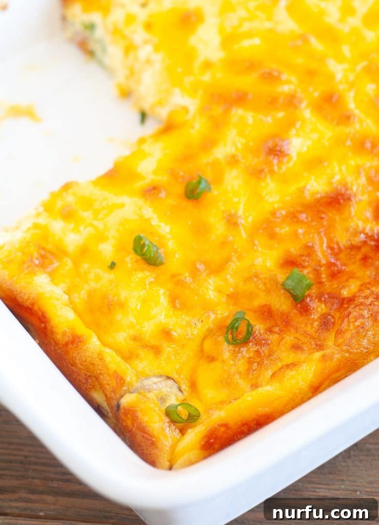 Keto Morning Bake 3 Keto breakfast casserole in a baking dish with piece cut out