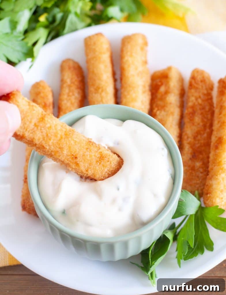 Homemade Creamy Tartar Sauce 2 Bowl of homemade tartar sauce with crispy fish sticks, ready to be enjoyed.