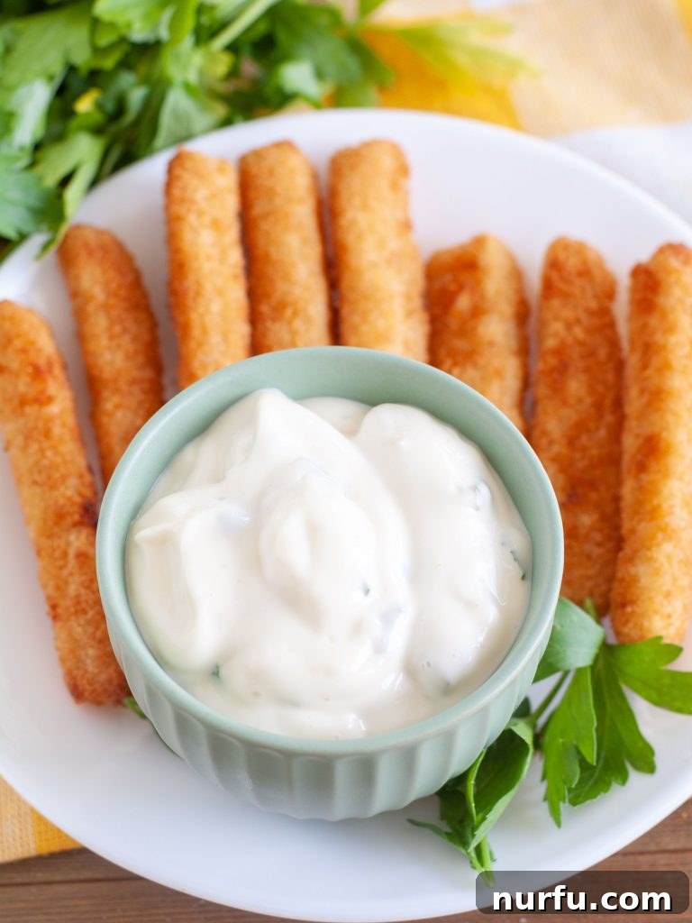 Homemade Creamy Tartar Sauce 5 Bowl of homemade tartar sauce ready to serve with fish sticks.