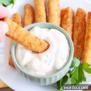 Bowl with tartar sauce and fish sticks