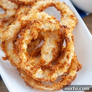 Crispy Air-Fried Onion Rings 6 Platter of golden brown, crispy air fryer onion rings.