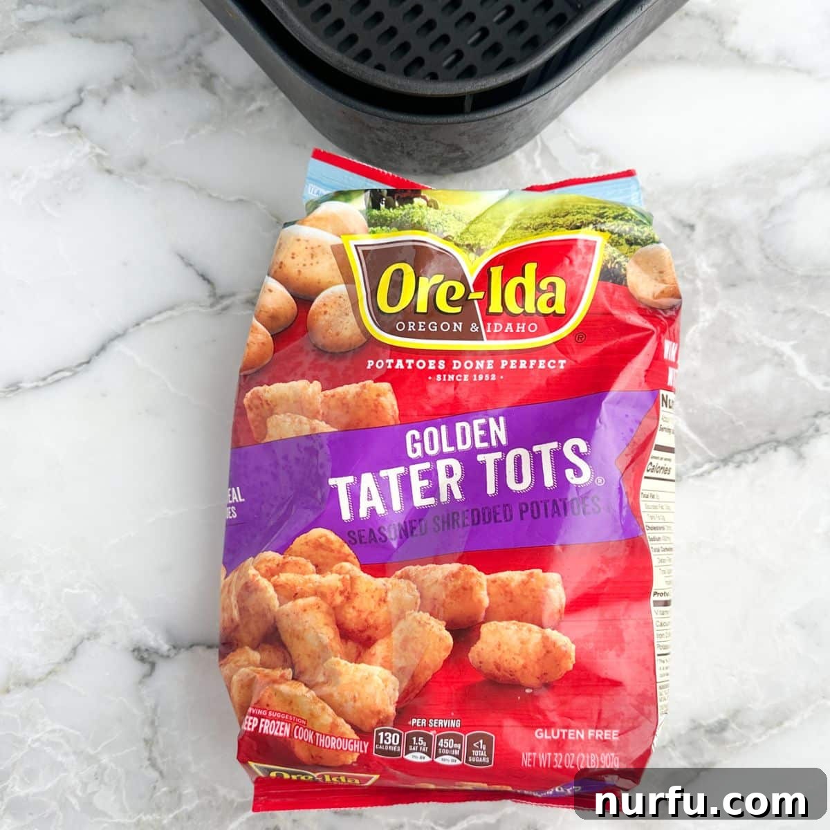 Golden Crispy Air Fryer Tots 3 A bag of frozen tater tots next to an air fryer basket, ready for cooking
