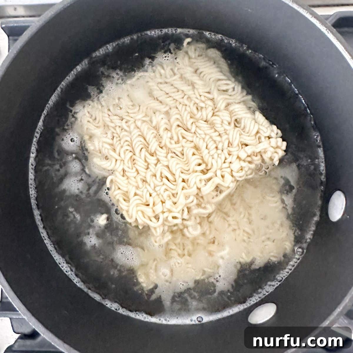Savory Ground Beef Ramen 5 Pot with water and ramen noodles.