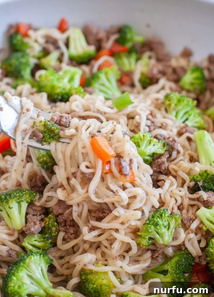Savory Ground Beef Ramen 8 Noodles on a fork with peppers and broccoli
