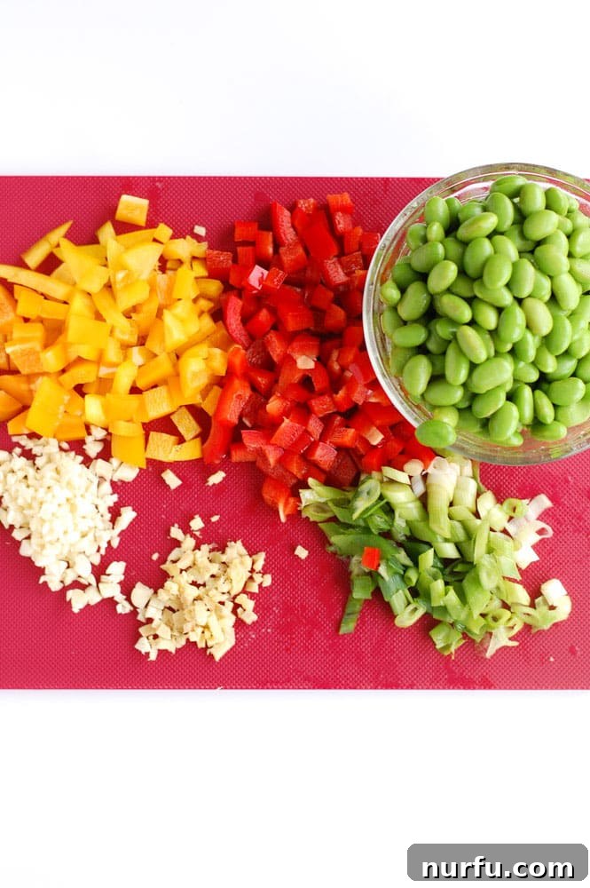 Close-up of a colorful chicken edamame bowl, showcasing a mix of chicken, bell peppers, and edamame