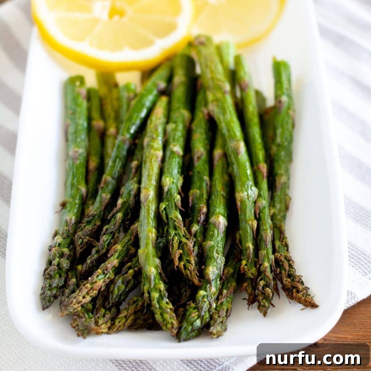 Golden Air Fryer Asparagus 2 Crispy, tender Air Fryer Asparagus on a plate, ready to be served.
