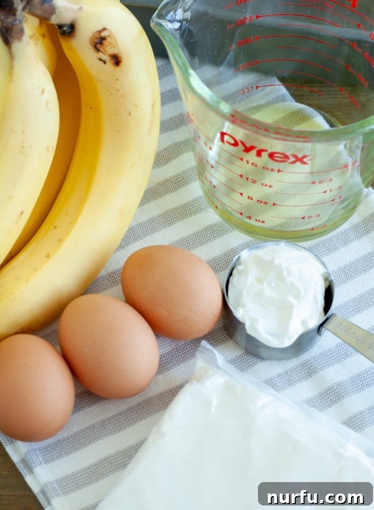 Easy Cake Mix Banana Bread 3 Key ingredients for an easy cake mix banana bread laid out: fresh eggs, perfectly ripe bananas, cooking oil, and creamy sour cream, ready for mixing.