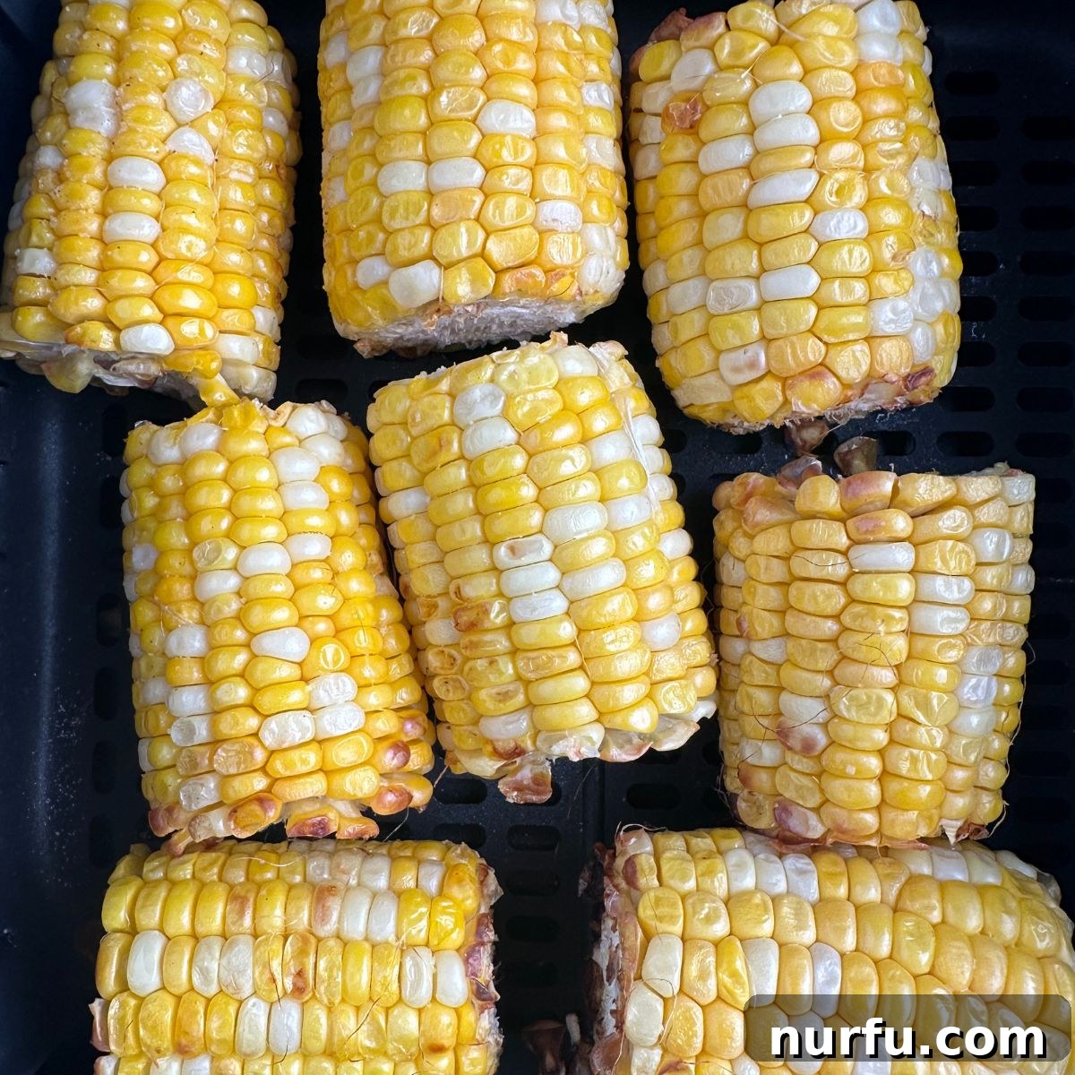 Perfect Air Fryer Corn 5 Cooked corn on the cob in an air fryer basket.