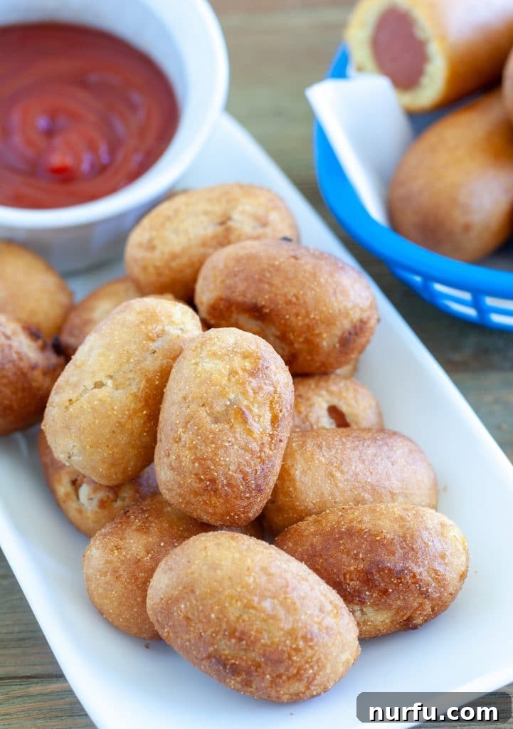 A plate of perfectly cooked mini corn dogs from the air fryer, ready to serve.