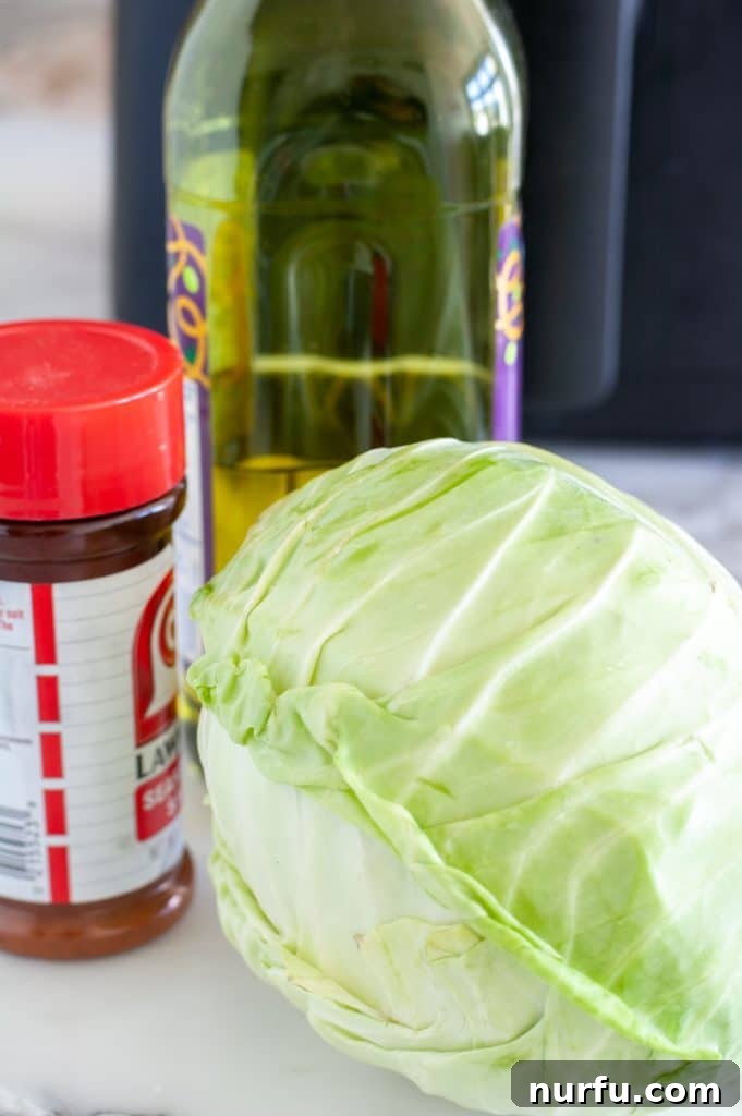 Crispy Air Fryer Cabbage 3 Ingredients for air fryer roasted cabbage: a head of green cabbage, olive oil, and seasoned salt.