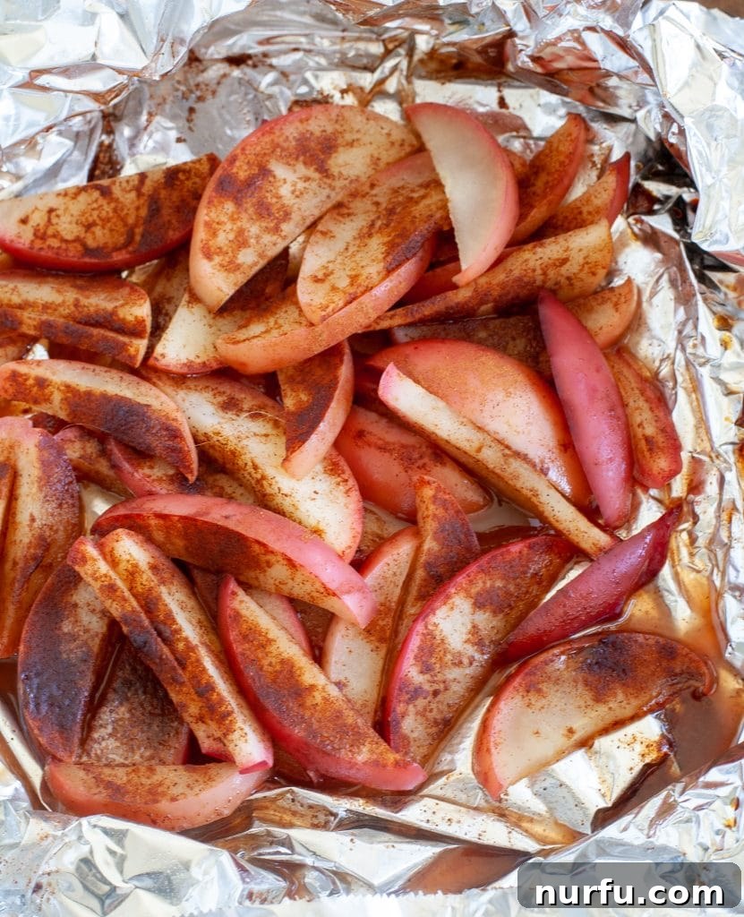 Caramelized Grilled Apples 3 Sliced apples with cinnamon and sugar in foil ready to be grilled, viewed from above.