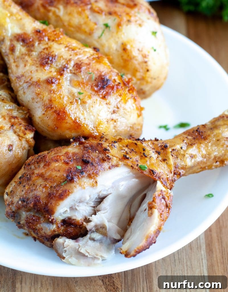 Crispy Air Fryer Drumsticks 4 A delicious, crispy air fryer chicken drumstick with a bite taken out, showing the tender meat inside