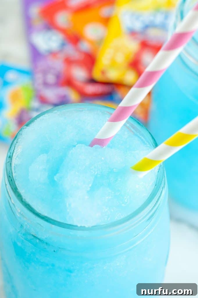 Crafting Your Perfect Slushie 2 A vibrant blue homemade slushie served in a tall glass, garnished with a straw, capturing the essence of a refreshing summer treat.