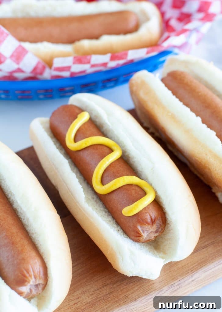 Mastering the Boiled Hot Dog 2 Three hotdogs in buns on a board, ready to be served