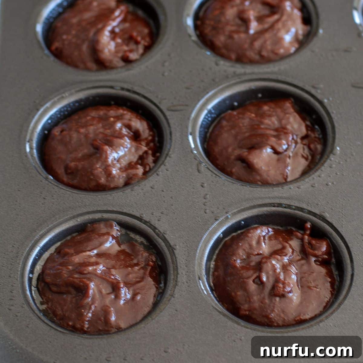 Coffee Kick Brownie Bites 4 Mini muffin tin filled with raw espresso brownie batter, ready for baking.