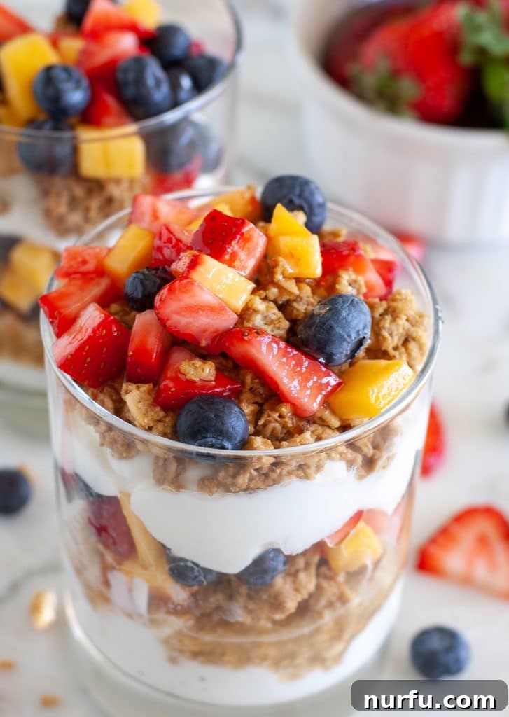 Yogurt parfait in a glass with mixed berries and granola