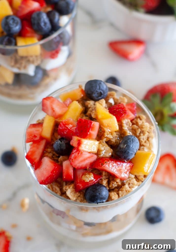 Cup with fruit, granola and yogurt from top view