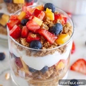 Yogurt parfait in a glass with granola and berries