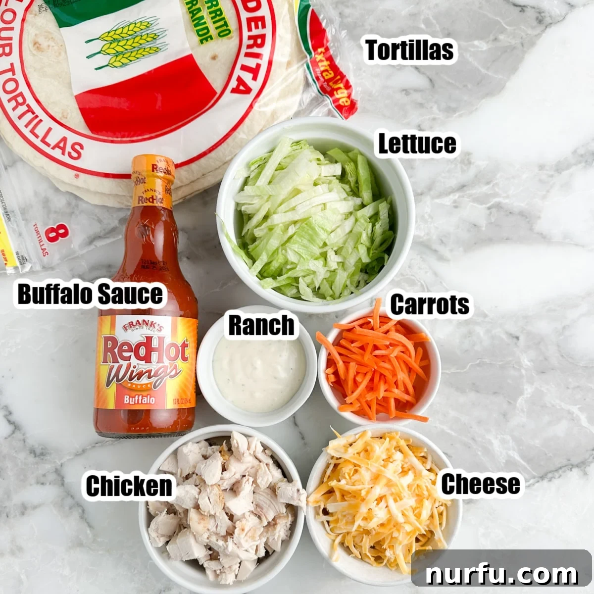 Zesty Buffalo Chicken Wraps 3 Tortillas, bowl of lettuce, carrots, cheese, ranch, chicken, and buffalo sauce.