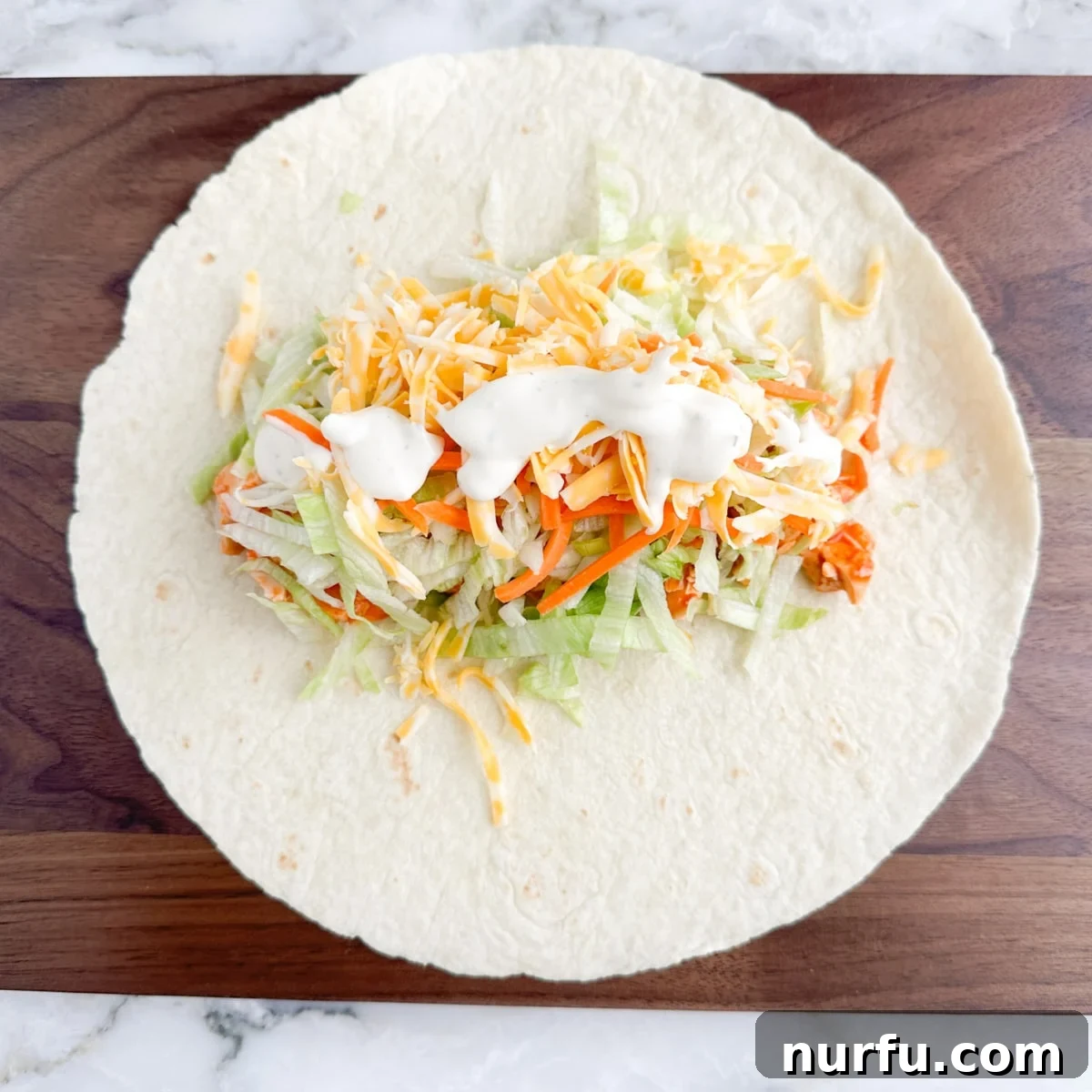 Zesty Buffalo Chicken Wraps 6 Tortilla with buffalo chicken, lettuce, cheese, and ranch.