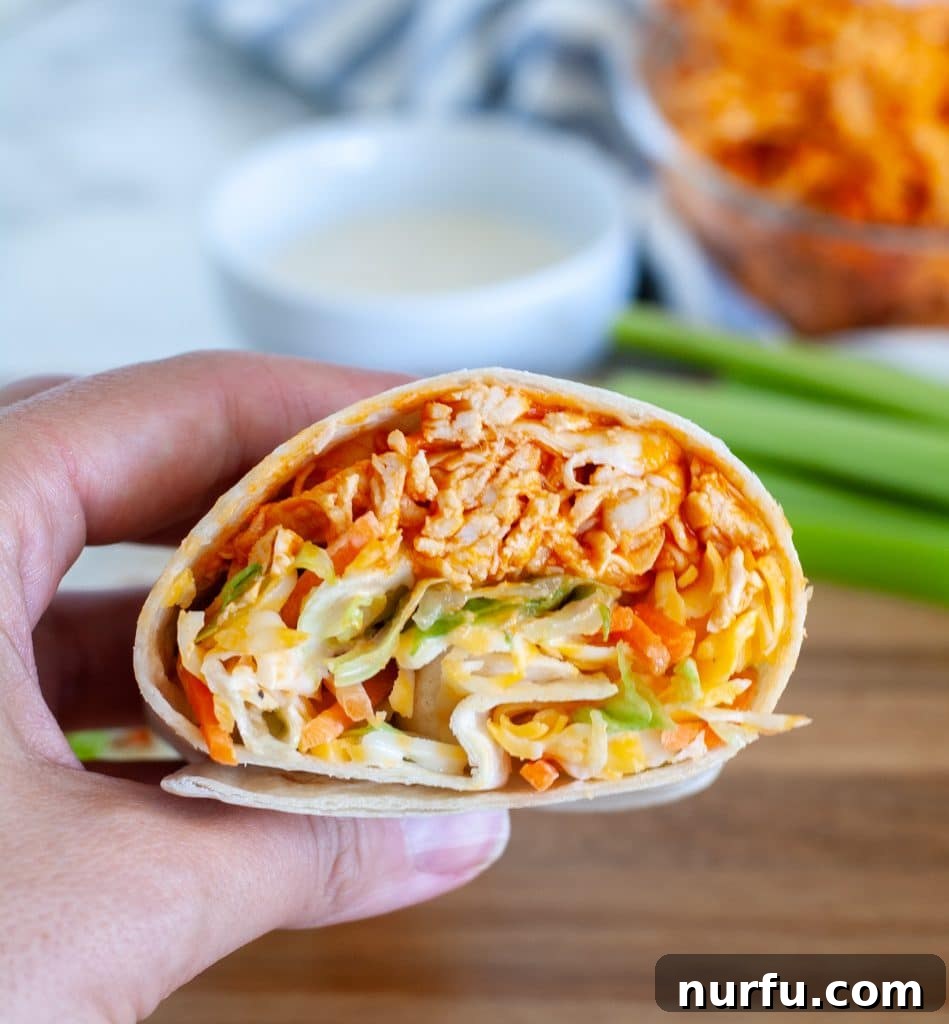 Zesty Buffalo Chicken Wraps 8 hand holding chicken wrap
