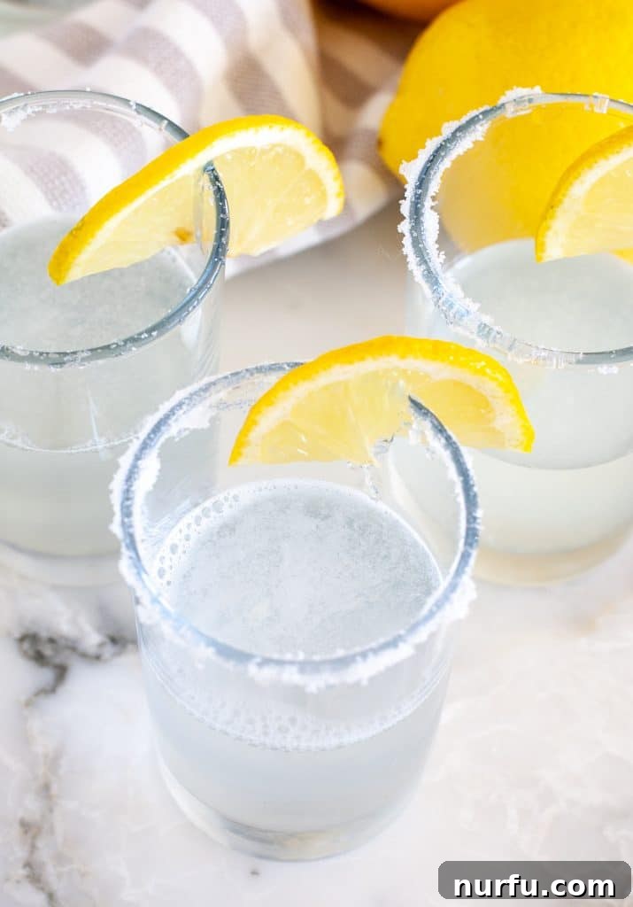 Zesty Lemon Shooters 4 Shot glass with vodka and lemon wedge