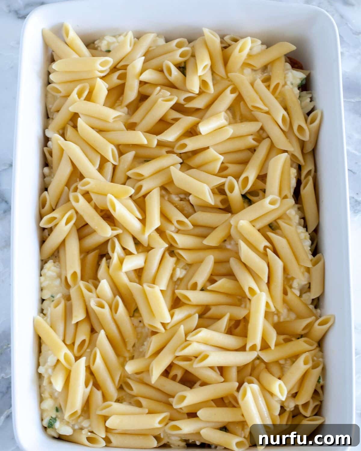 Cheesy Baked Mostaccioli 6 Spreading the creamy cottage cheese mixture over the pasta layer.