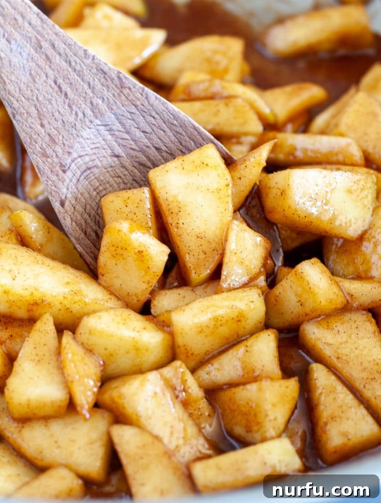 Sweet Skillet Apples 2 Skillet of cinnamon apples with wooden spoon