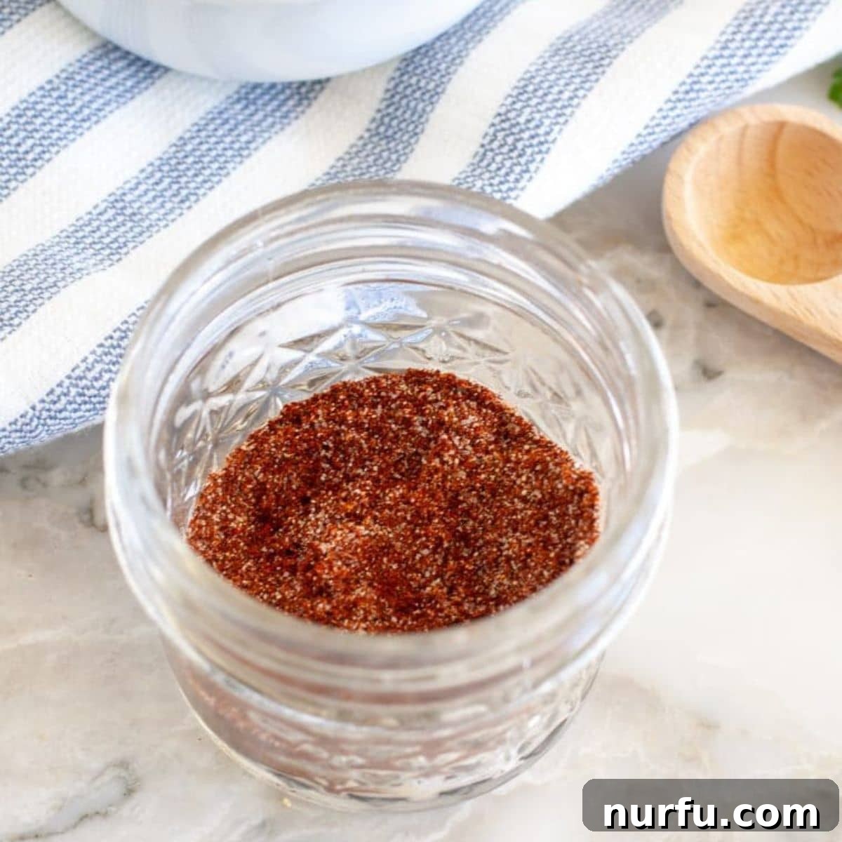 Craft Your Own Chili Spice Blend 5 A small bowl of chili seasoning next to a larger bowl of prepared chili, symbolizing the journey from spice mix to finished dish.