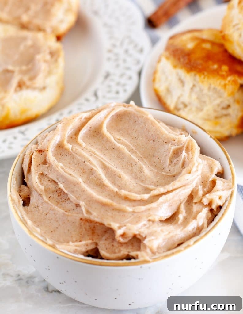 Copycat Texas Roadhouse Cinnamon Butter 2 Cinnamon butter in a bowl with biscuits