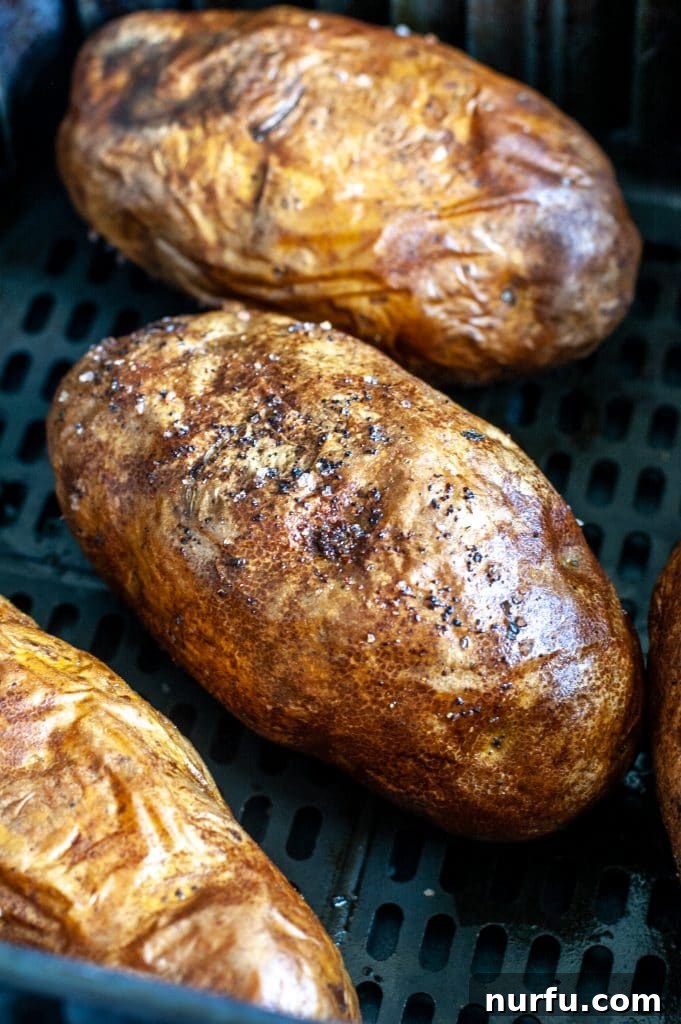 Crisp Air Fryer Baked Potatoes 4 Potatoes in air fryer basket