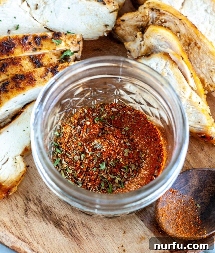 Ultimate Chicken Flavor Mix 2 seasonings in a jar with sliced chicken
